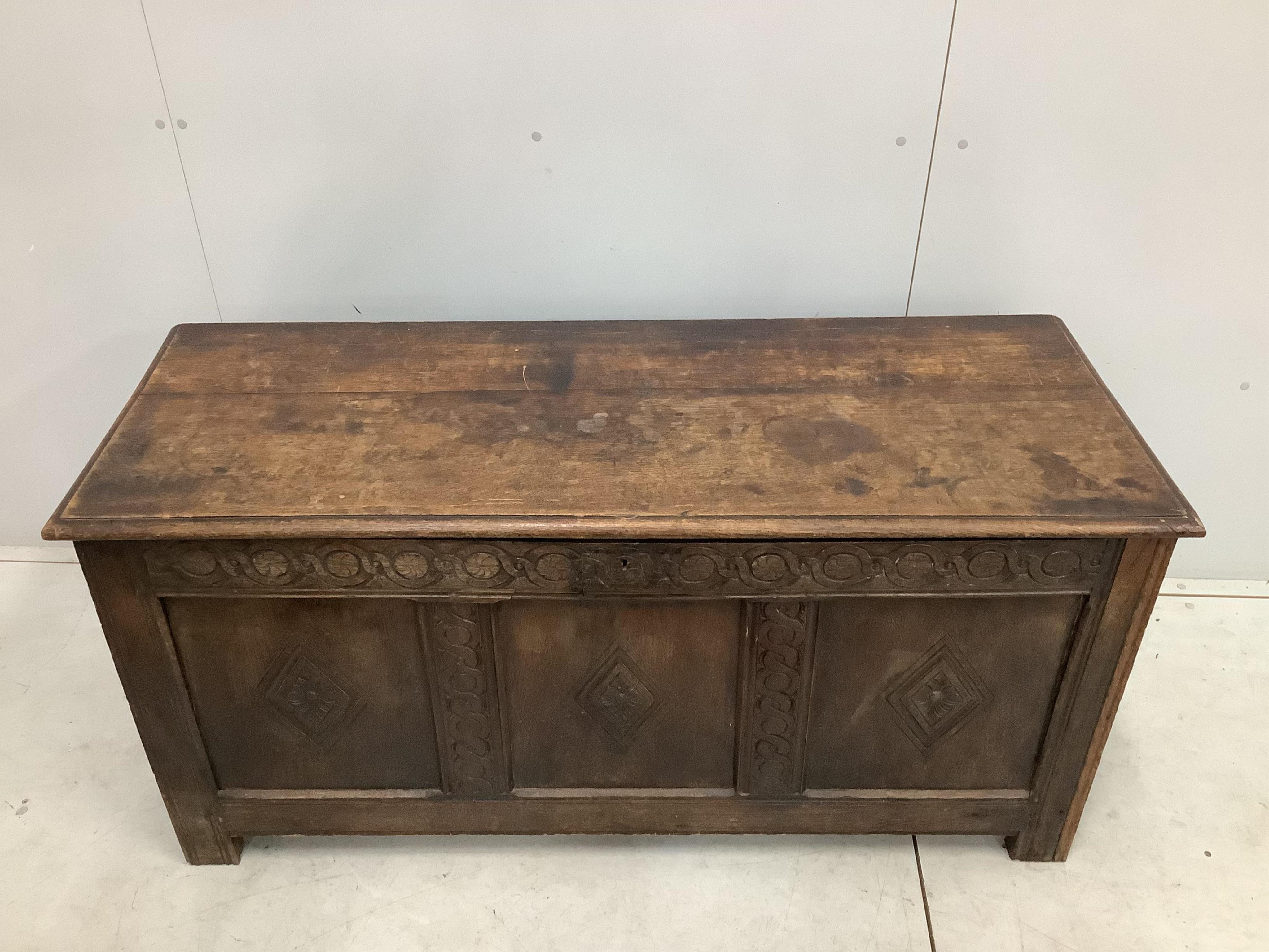 An 18th century carved oak coffer, width 141cm, depth 53cm, height 68cm. Condition - fair